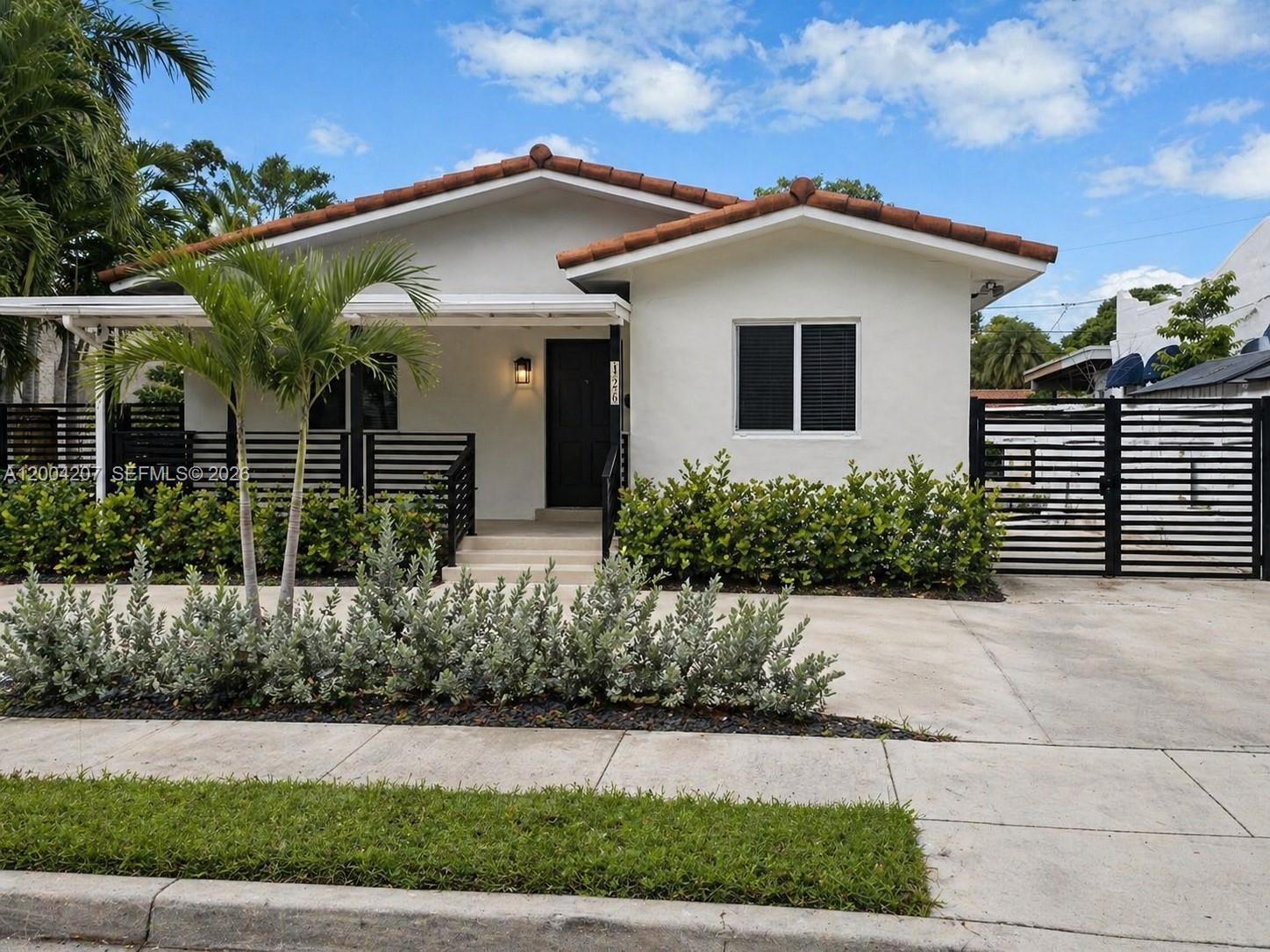 426 Southwest 26th Road Miami, FL 33129 - Photo 1 of 9 a front view of a house with garden