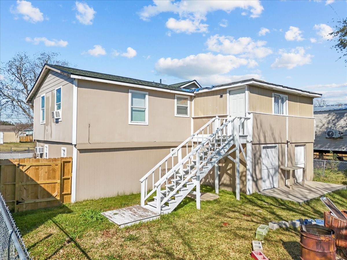 711 10th Street Dickinson, TX 77539 - Photo 31 of 33 Backyard with stairwell leading to upstairs bonus room