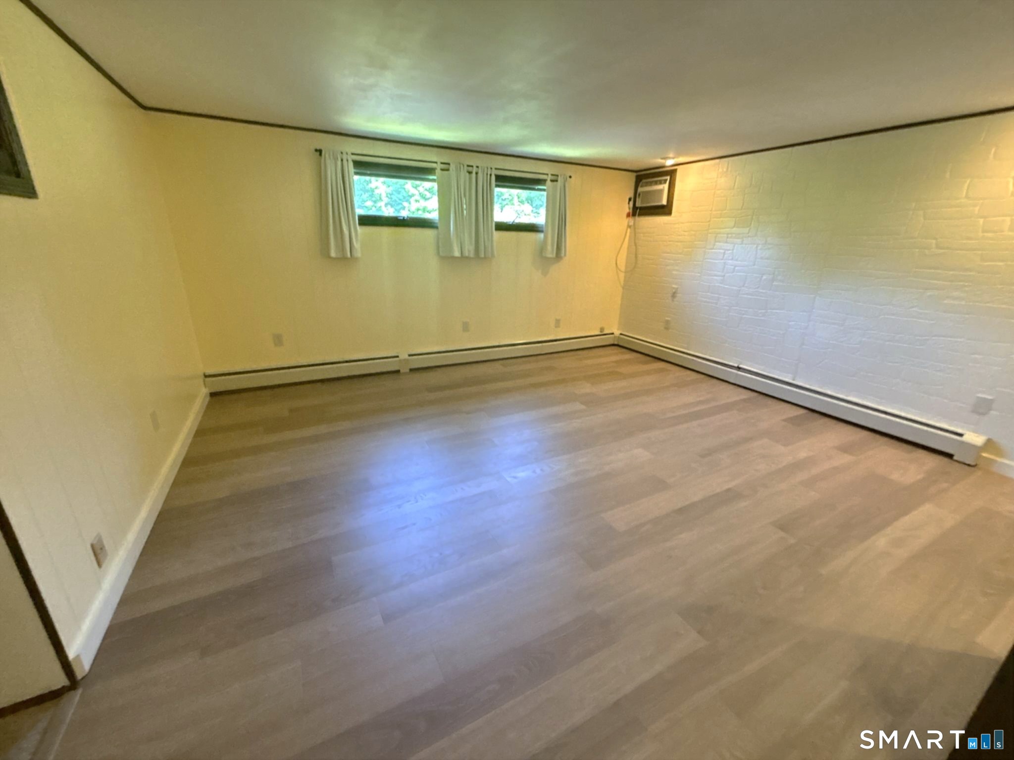 44 Summit Road Prospect, CT 06712 - Photo 18 of 40 an empty room with wooden floor and windows