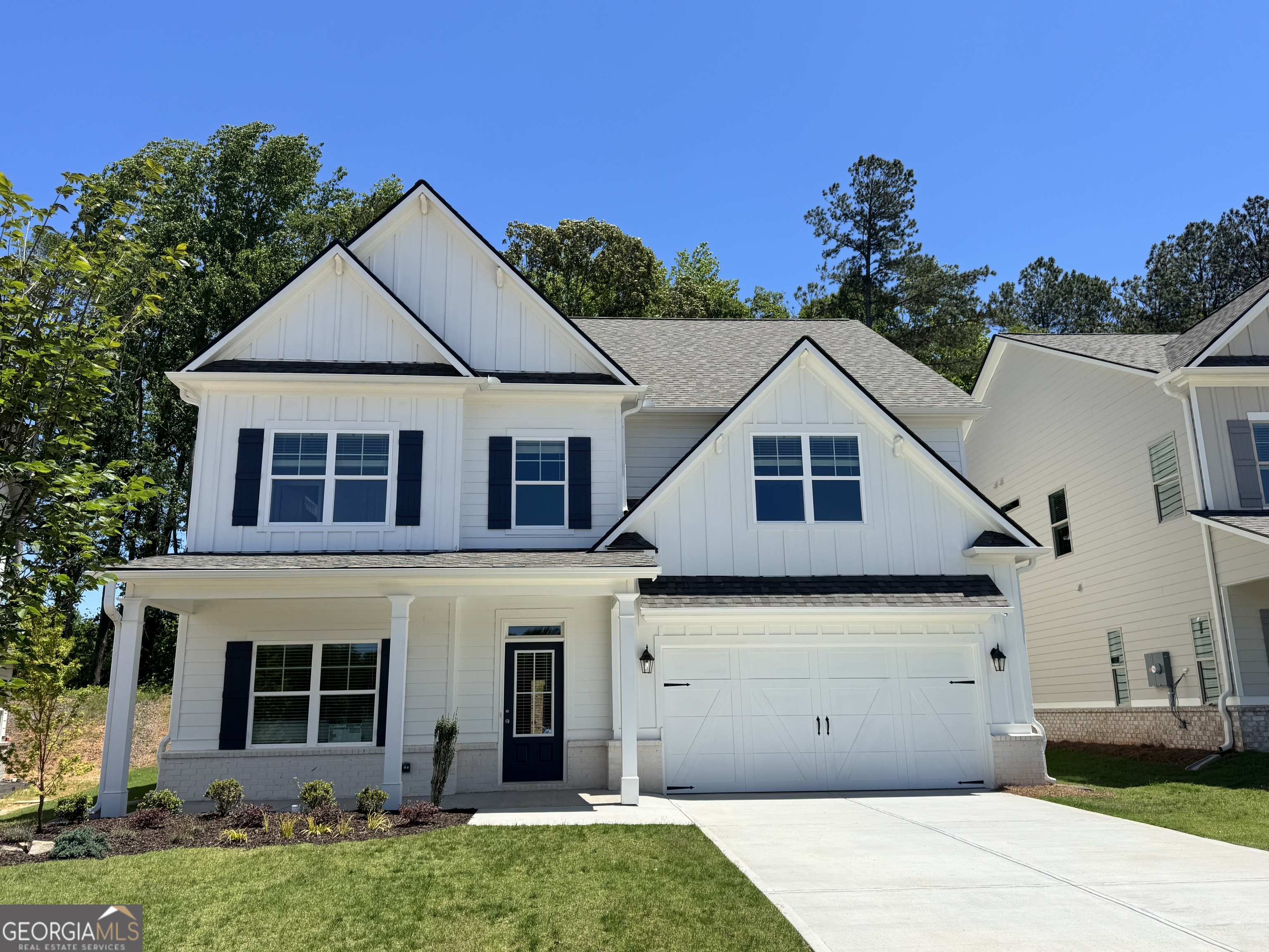a view of a house with a yard and garage
