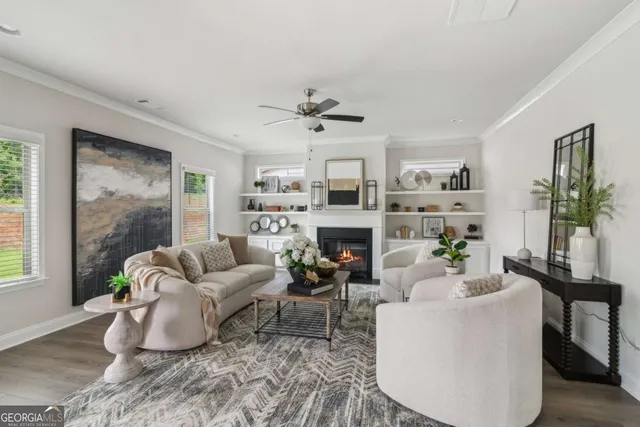 a living room with furniture a fireplace and a potted plant