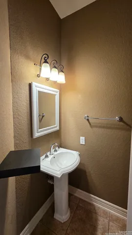 a bathroom with a sink a mirror and a toilet