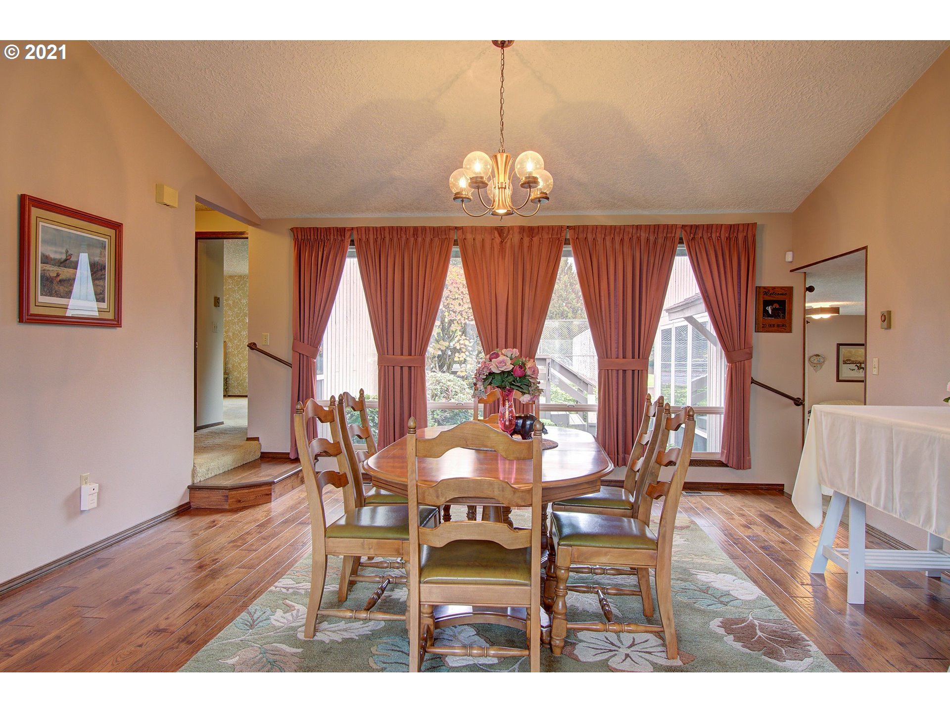 3408 Northeast 161st Street Ridgefield, WA 98642 - Photo 3 of 29 a view of a dining room with furniture wooden floor and chandelier
