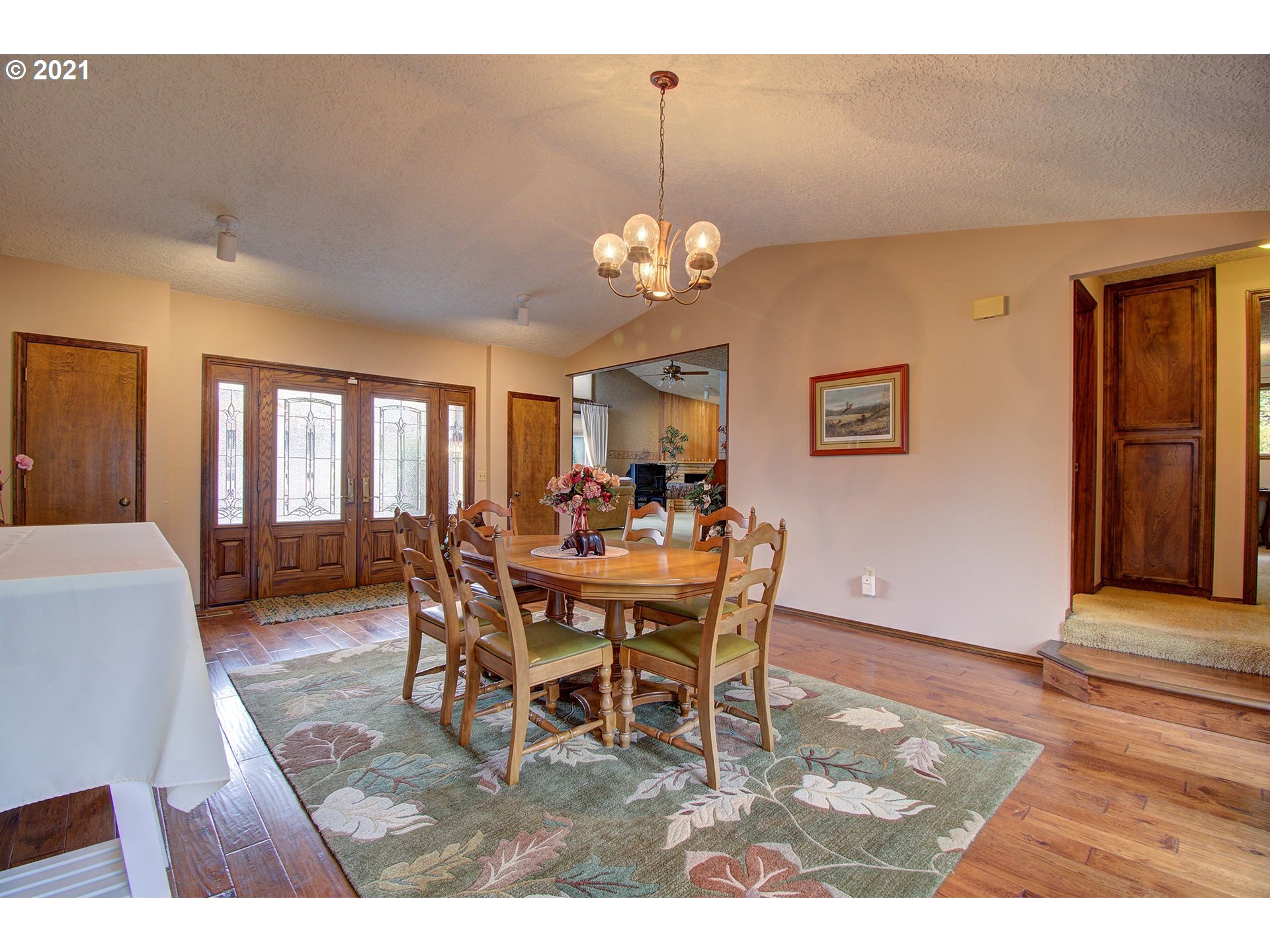 3408 Northeast 161st Street Ridgefield, WA 98642 - Photo 4 of 29 a view of a dining room with furniture and a chandelier