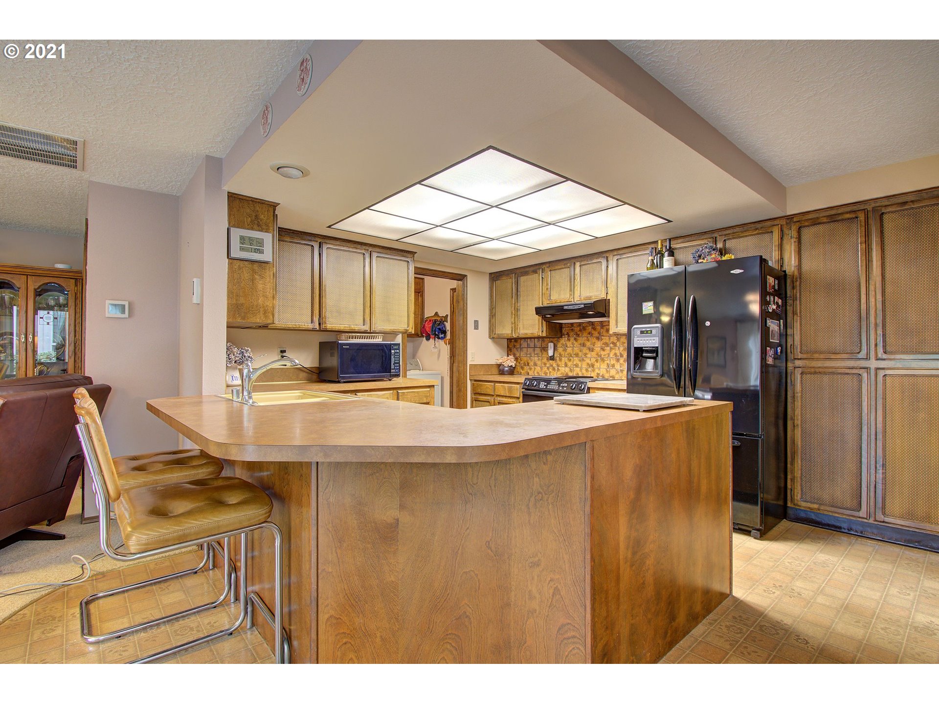3408 Northeast 161st Street Ridgefield, WA 98642 - Photo 8 of 29 a kitchen with kitchen island a counter top space a sink stainless steel appliances and cabinets