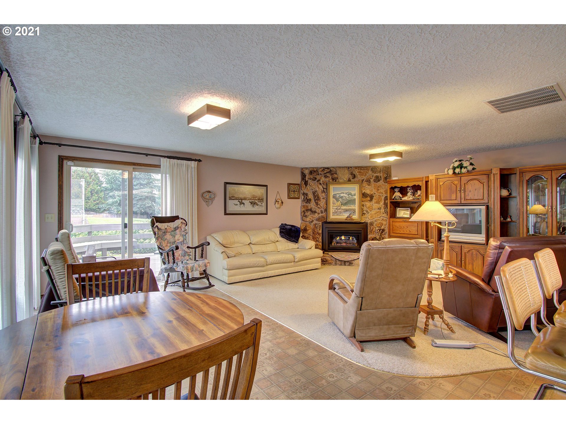 3408 Northeast 161st Street Ridgefield, WA 98642 - Photo 9 of 29 a living room with furniture a dining table and large windows