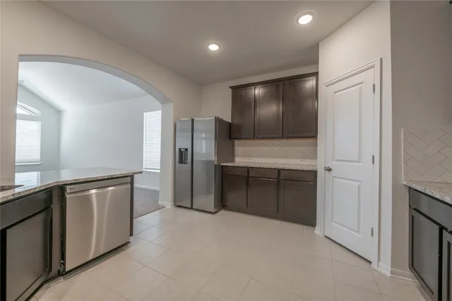a large kitchen with cabinets and stainless steel appliances