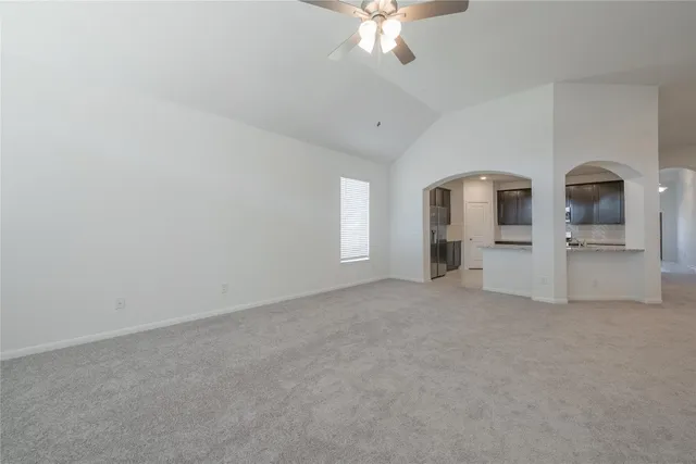 an empty room with a empty space and chandelier fan