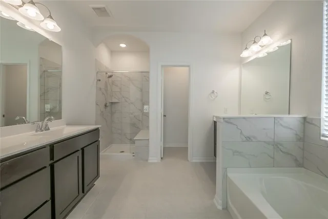 a bathroom with a double vanity sink and a mirror