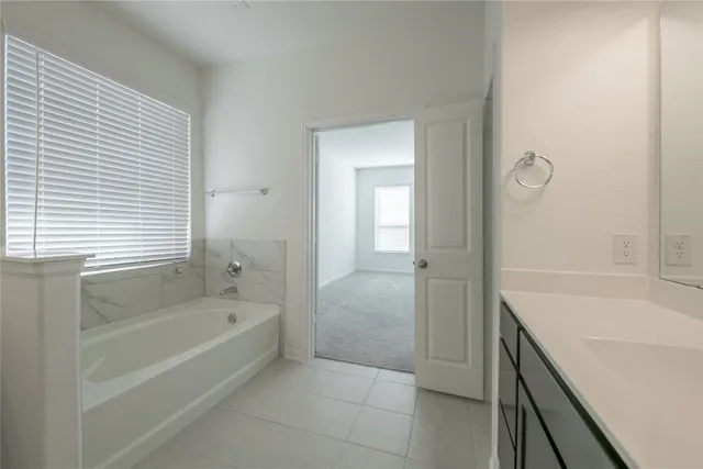 a bathroom with a bathtub and shower
