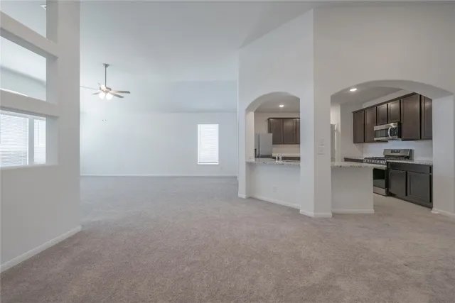 a view of a kitchen and an entryway with a kitchen
