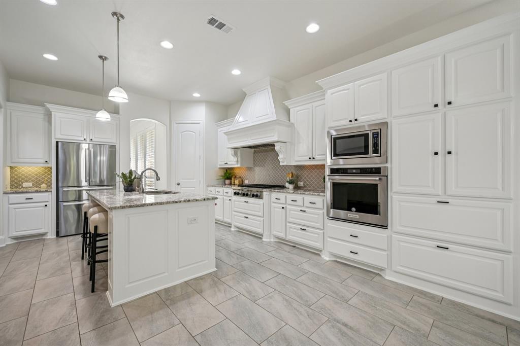 2029 Temperate Drive Allen, TX 75013 - Photo 8 of 40 a kitchen with stainless steel appliances a stove cabinets and a view of kitchen