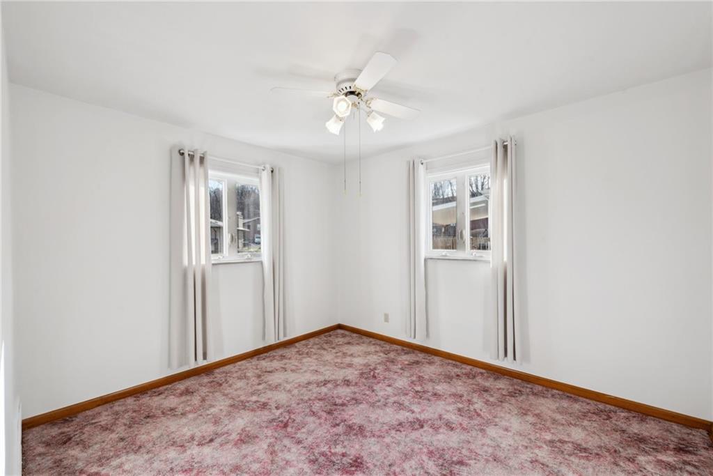 614 Maple Street Jeannette, PA 15644 - Photo 14 of 26 an empty room with windows and ceiling fan