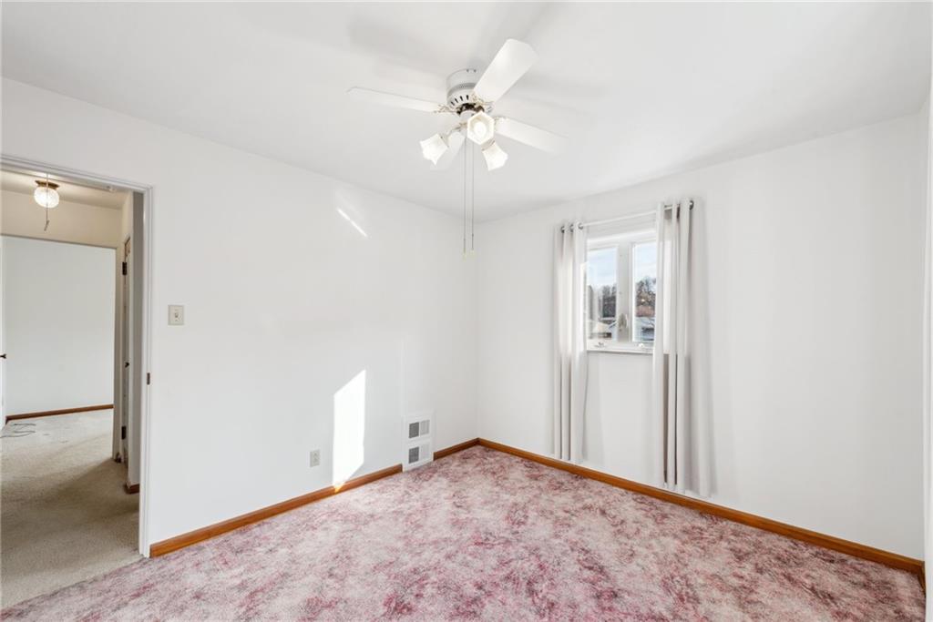 614 Maple Street Jeannette, PA 15644 - Photo 15 of 26 a view of a room with a ceiling fan and a window