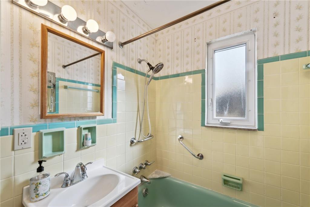 614 Maple Street Jeannette, PA 15644 - Photo 19 of 26 a bathroom with a sink and a mirror