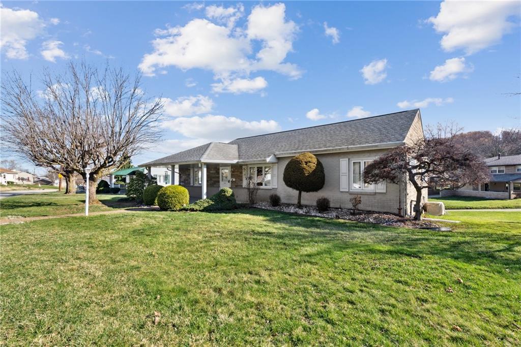614 Maple Street Jeannette, PA 15644 - Photo 3 of 26 a view of a house with a big yard and large trees