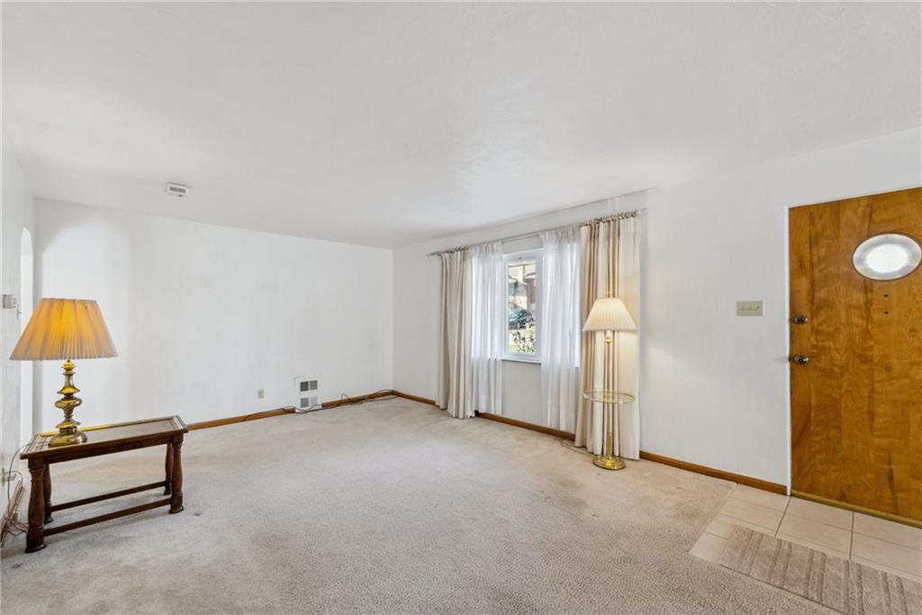 614 Maple Street Jeannette, PA 15644 - Photo 6 of 26 an empty room with a window and a lamp