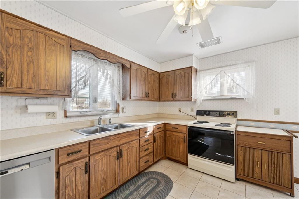 614 Maple Street Jeannette, PA 15644 - Photo 10 of 26 a kitchen with a stove sink and cabinets