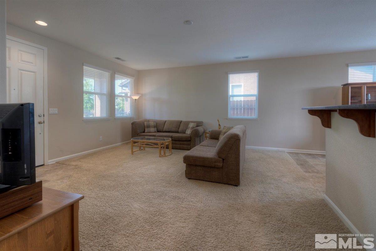 8955 Convair Way Reno, NV 89506 - Photo 8 of 19 a living room with furniture and a flat screen tv
