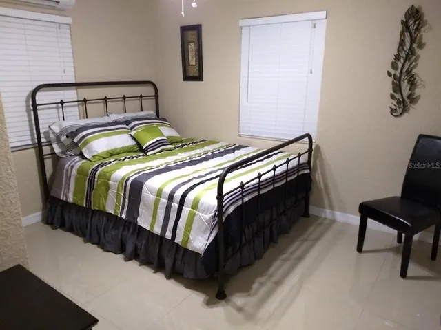 a bedroom with a bed and chair