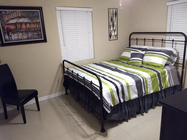 a bedroom with a bed and chair