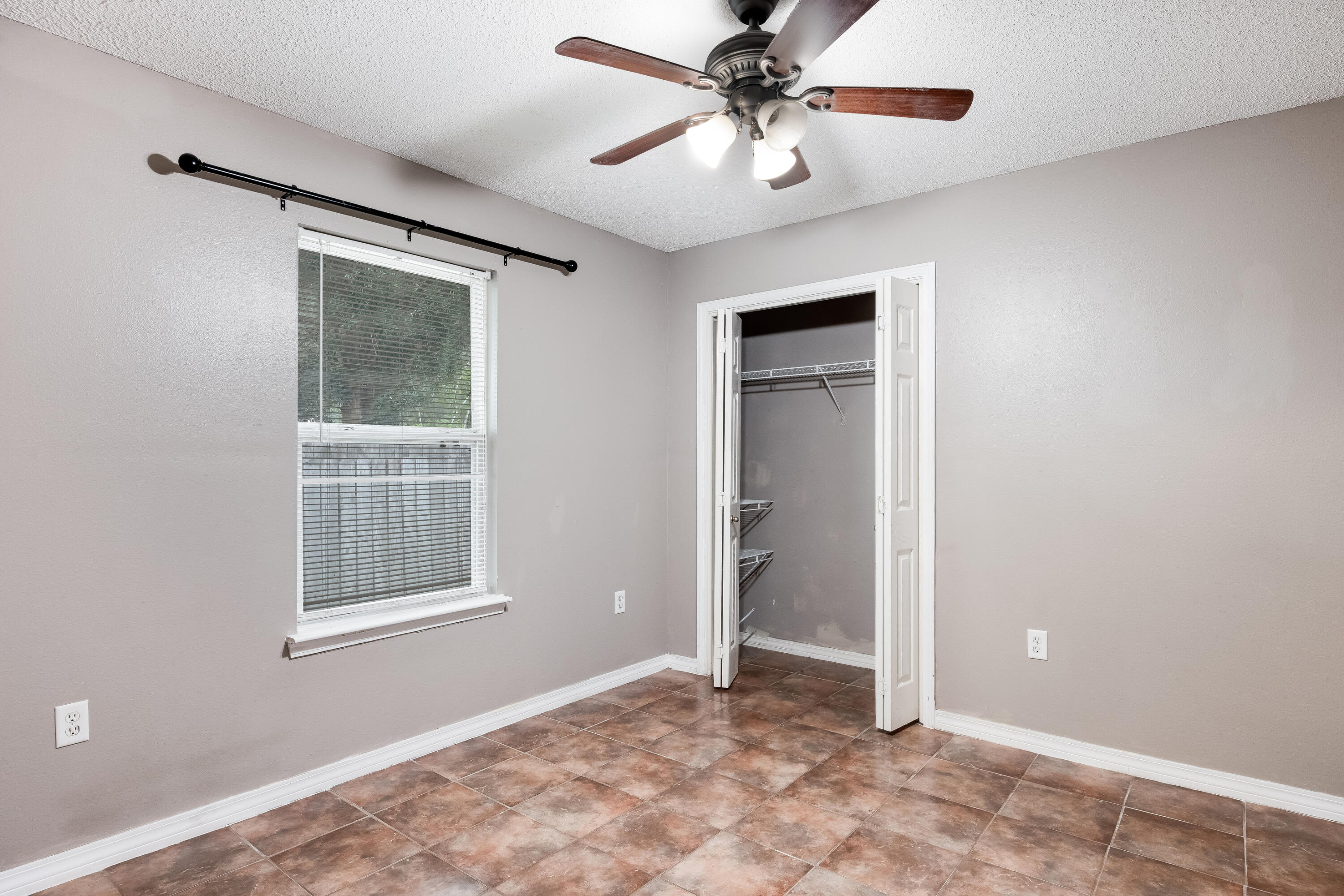 203 8th Avenue Crestview, FL 32536 - Photo 13 of 17 an empty room with windows and fan