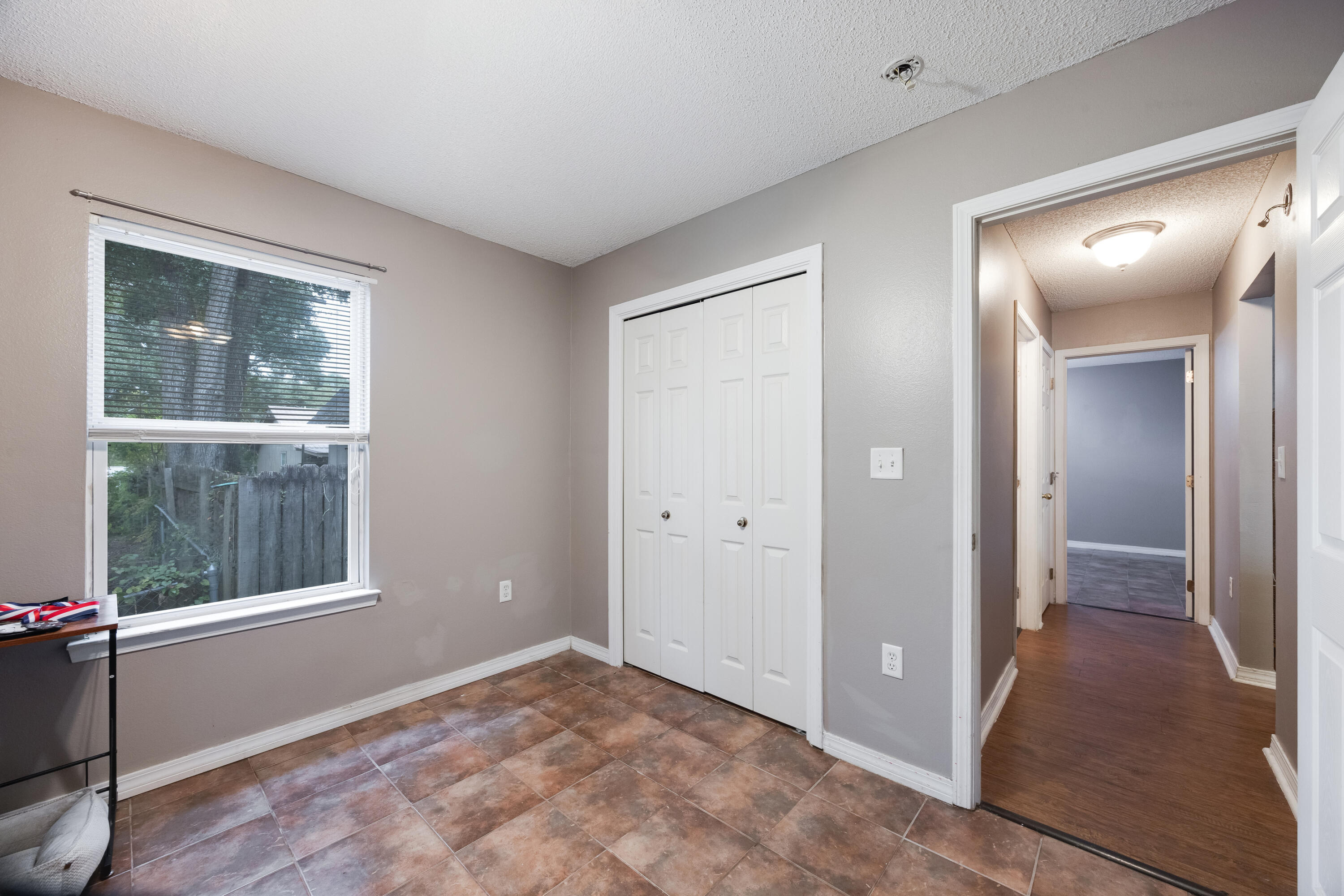 203 8th Avenue Crestview, FL 32536 - Photo 14 of 17 a view of an empty room with window and wooden floor