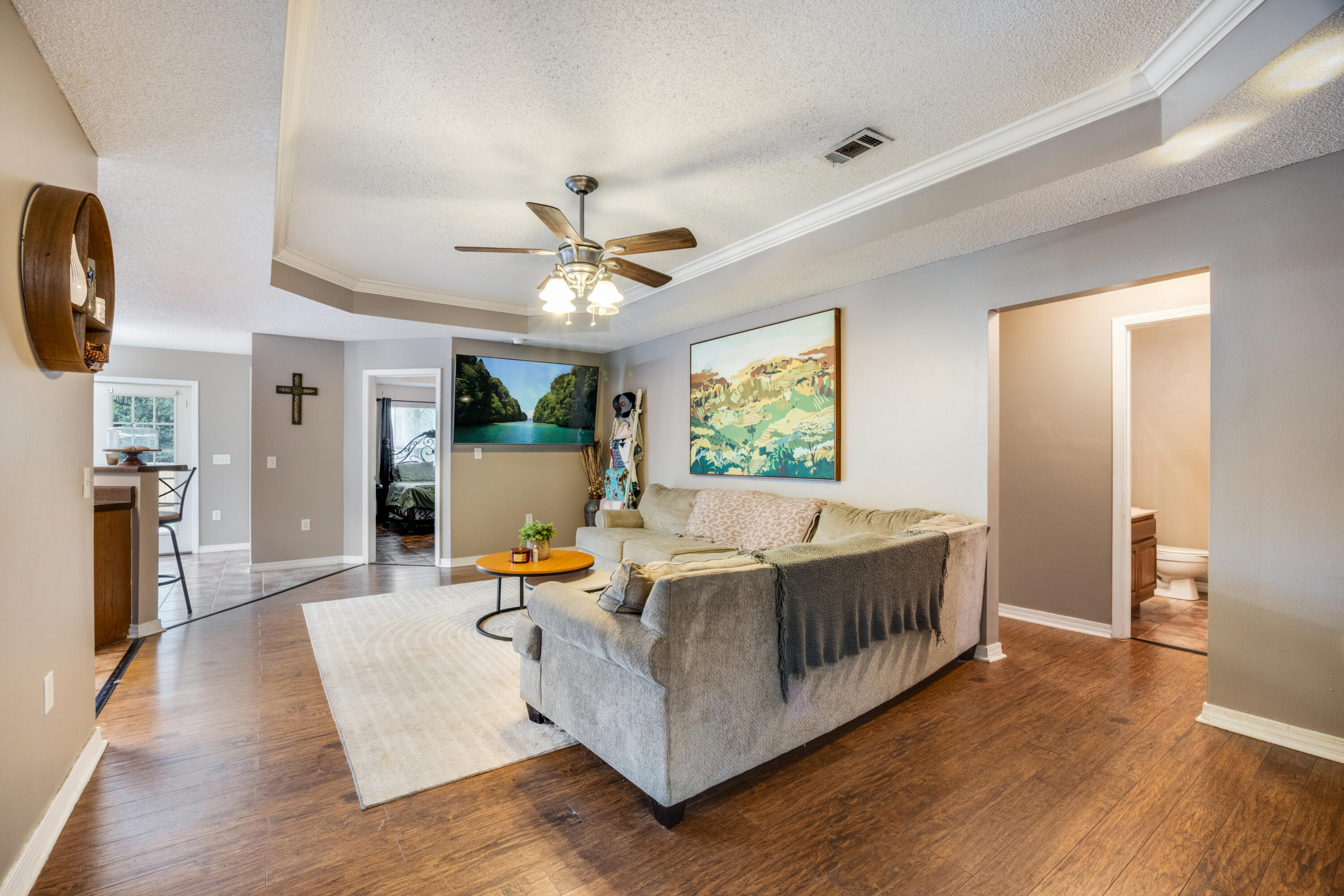 203 8th Avenue Crestview, FL 32536 - Photo 2 of 17 a living room with furniture and a chandelier