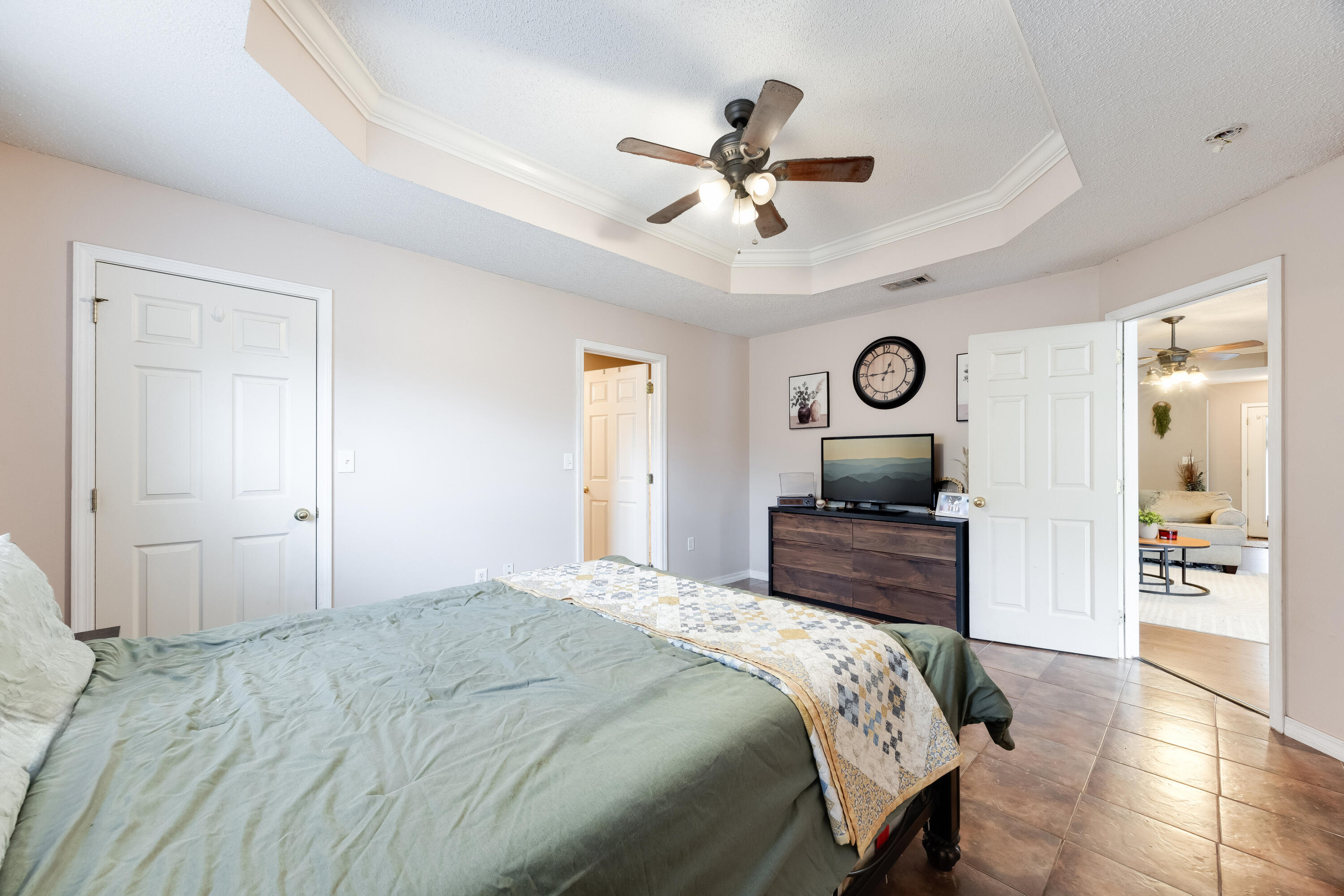 203 8th Avenue Crestview, FL 32536 - Photo 5 of 17 a bedroom with a bed and a chandelier