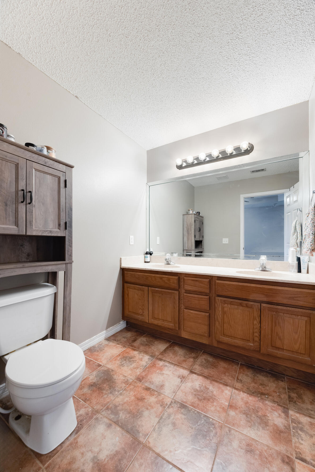 203 8th Avenue Crestview, FL 32536 - Photo 6 of 17 a bathroom with a toilet sink and mirror