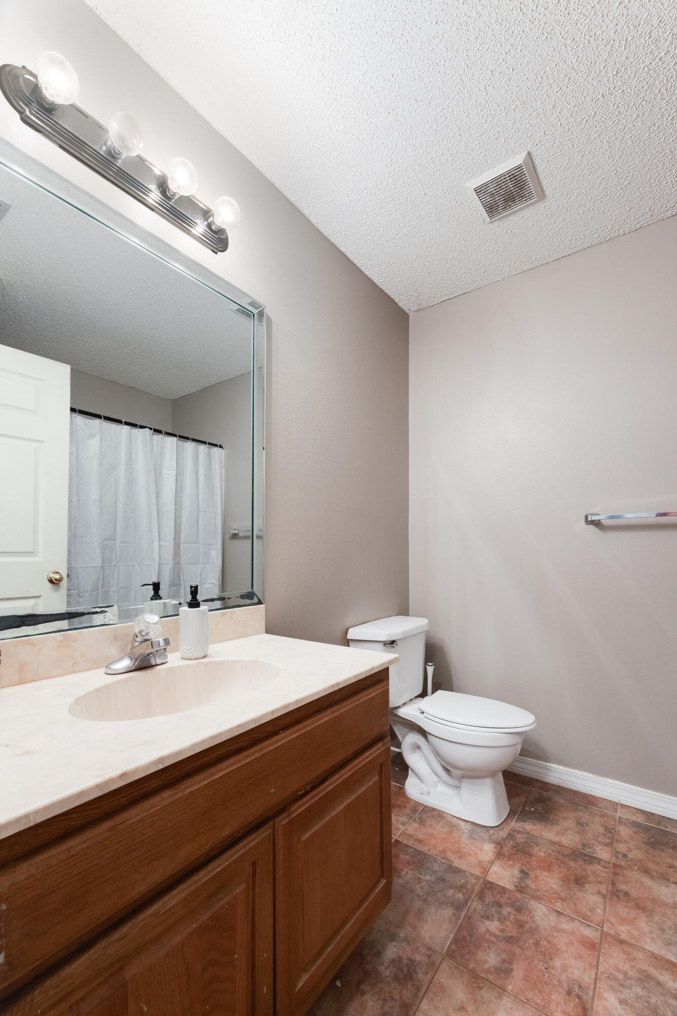 203 8th Avenue Crestview, FL 32536 - Photo 7 of 17 a bathroom with a sink a toilet and a mirror