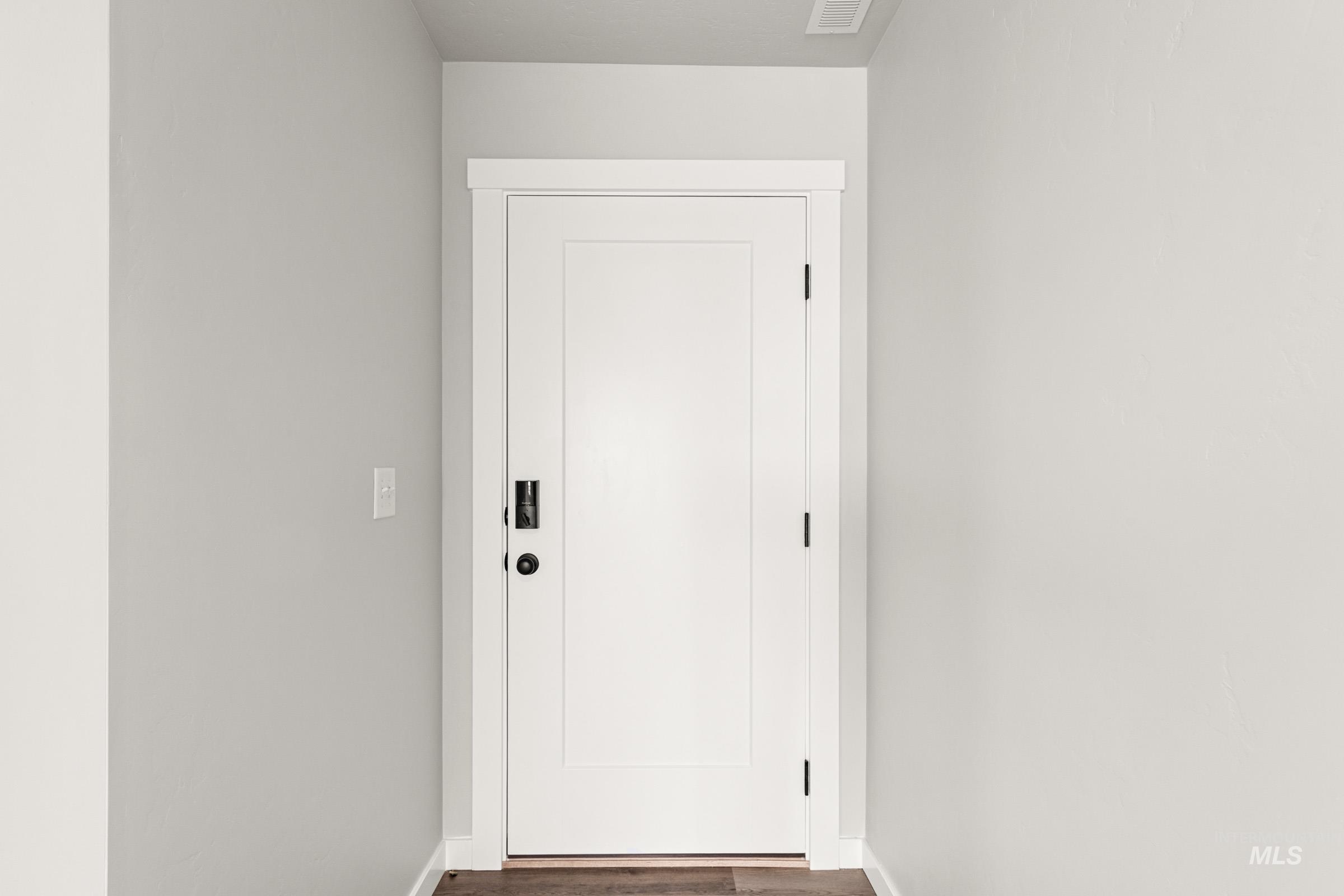 12830 Ropers Street Nampa, ID 83651 - Photo 2 of 18 Modern white interior door with matte black hardware, framed by crisp white trim