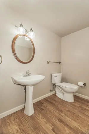 a bathroom with a toilet sink and mirror