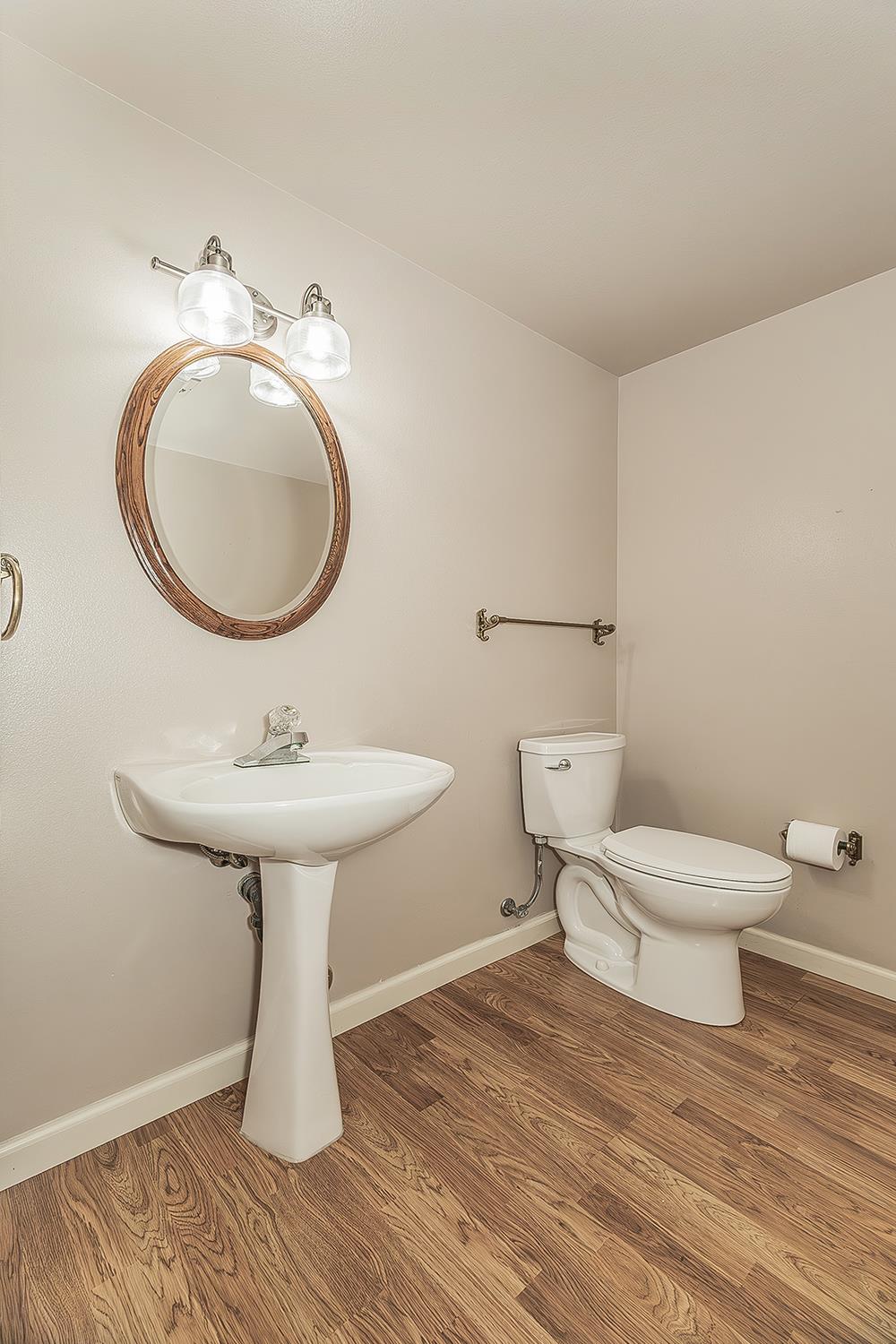 1282 West Flora Avenue Reedley, CA 93654 - Photo 12 of 49 a bathroom with a toilet sink and mirror