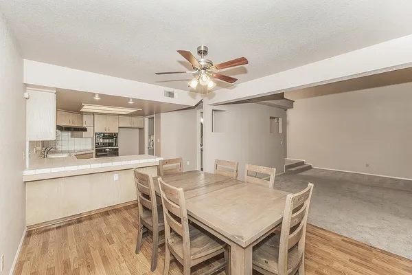 a kitchen with granite countertop white cabinets and white appliances