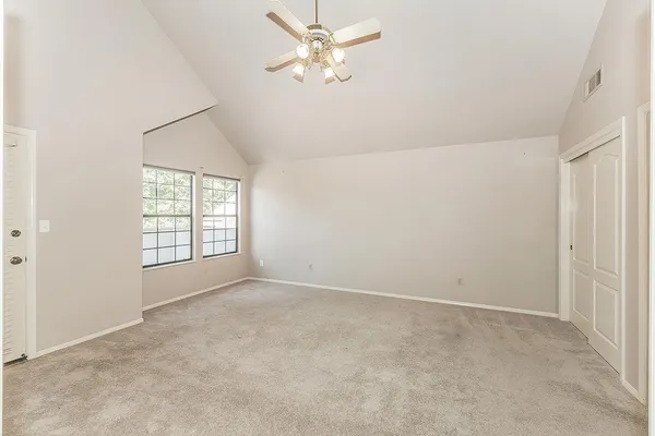 a view of an empty room with a chandelier