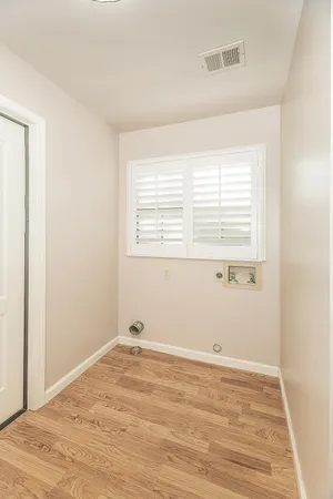 a view of a hallway with an empty room and a window