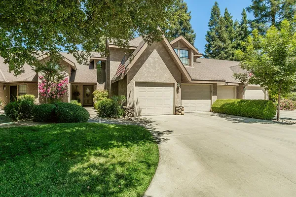 a view of house with yard and green space