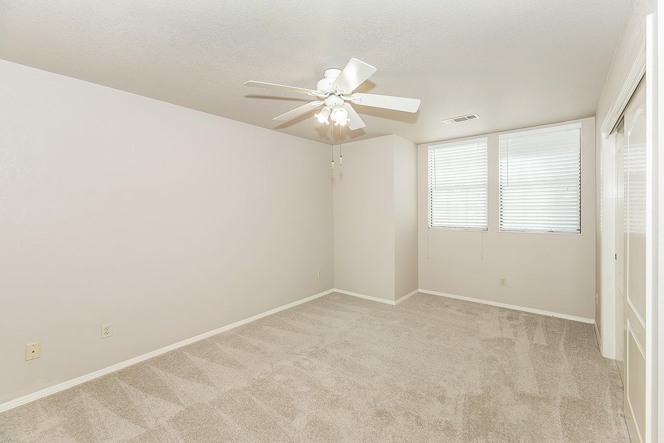 1282 West Flora Avenue Reedley, CA 93654 - Photo 23 of 49 an empty room with windows and fan
