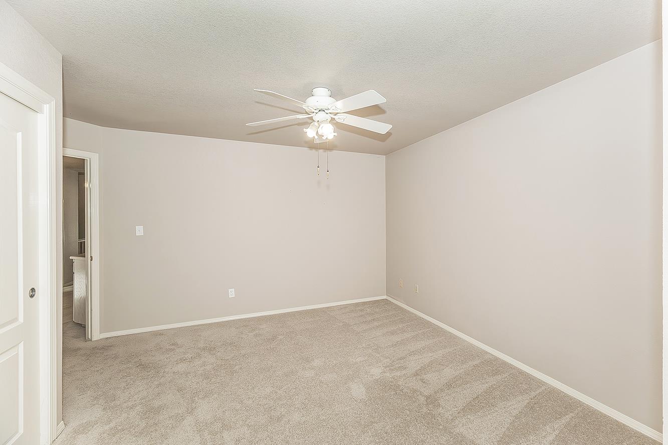 1282 West Flora Avenue Reedley, CA 93654 - Photo 25 of 49 a view of a room with a ceiling fan and a window