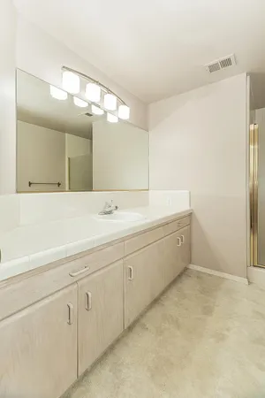 a view of an empty room with closet and a window