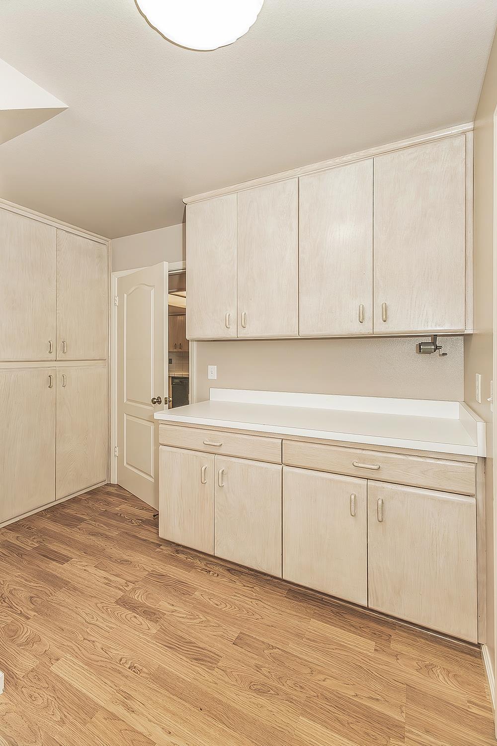 1282 West Flora Avenue Reedley, CA 93654 - Photo 37 of 49 a kitchen with granite countertop white cabinets and white appliances