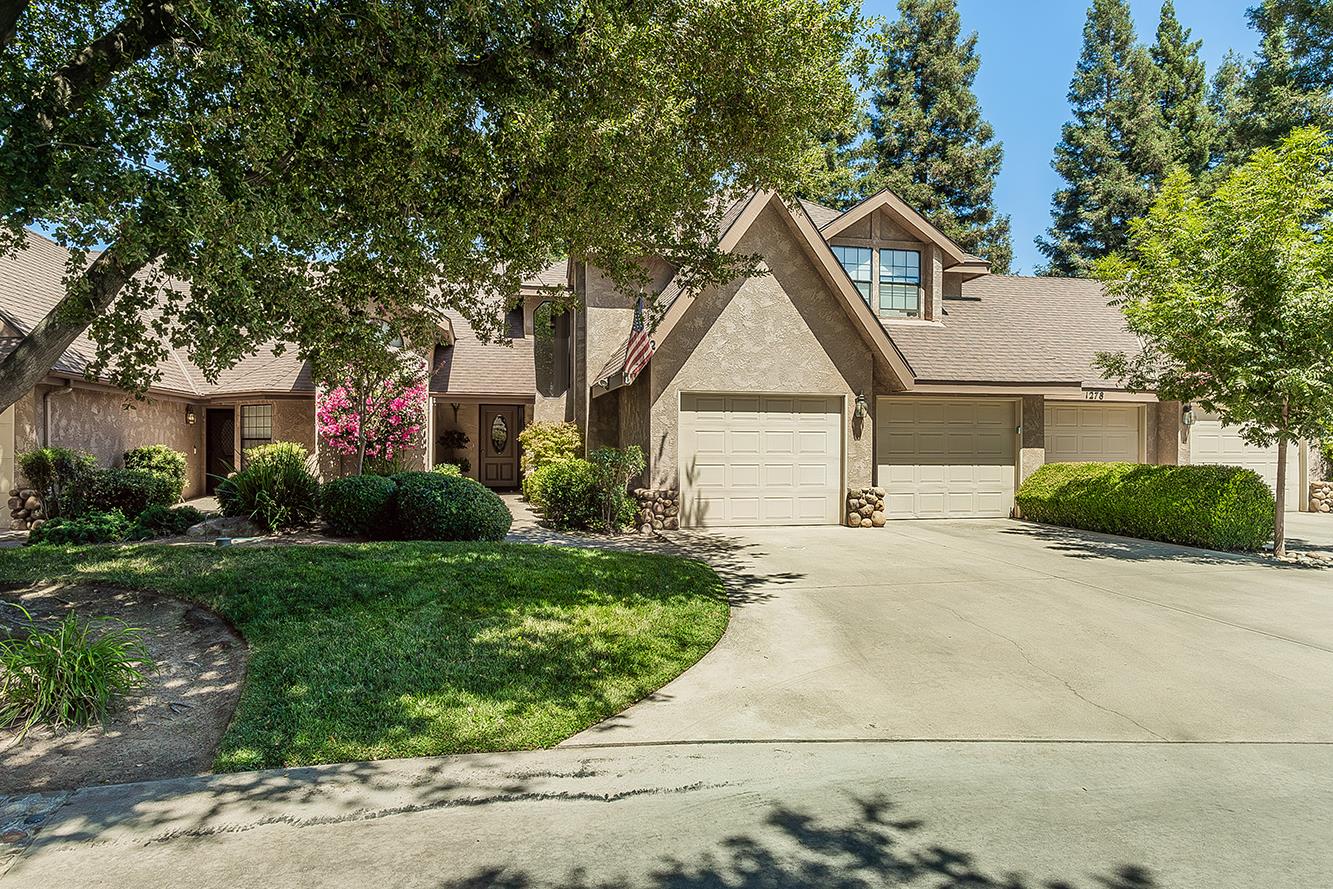 1282 West Flora Avenue Reedley, CA 93654 - Photo 5 of 49 a front view of a house with a yard and trees