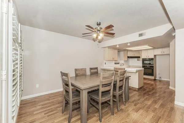 a view of a dining room with furniture and wooden floor