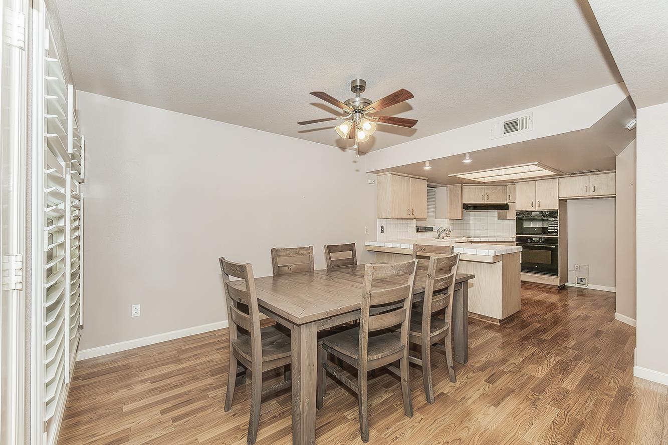 1282 West Flora Avenue Reedley, CA 93654 - Photo 9 of 49 a view of a dining room with furniture and wooden floor