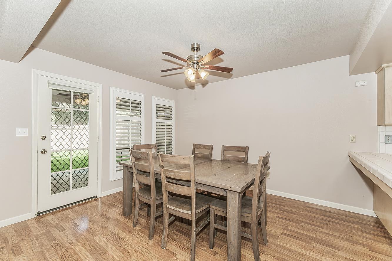 1282 West Flora Avenue Reedley, CA 93654 - Photo 10 of 49 a view of a dining room with furniture window and wooden floor