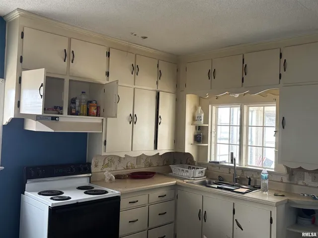 a kitchen with stainless steel appliances a stove a sink and a refrigerator