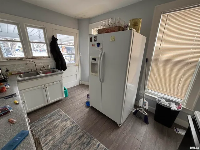a kitchen with a refrigerator and a sink
