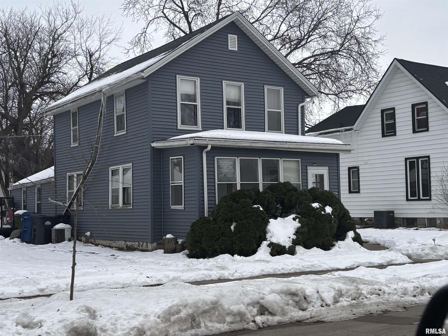2225 Pershing Boulevard Clinton, IA 52732 - Photo 7 of 7 a front view of a house with a yard covered in snow