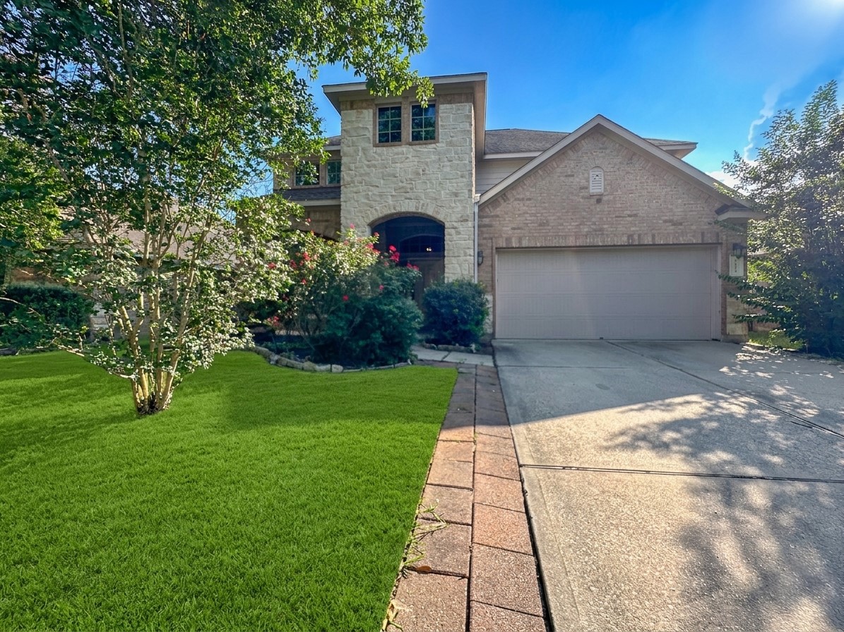 20319 Little Wing Drive Spring, TX 77388 - Photo 2 of 49 a front view of a house with garden